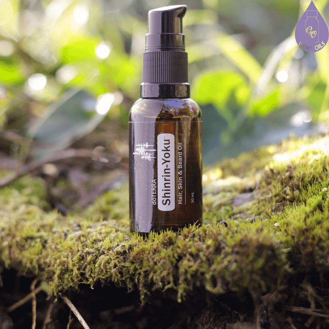 A bottle of Shinrin-Yoku Hair, Skin & Beard oil sitting on top of some moss.