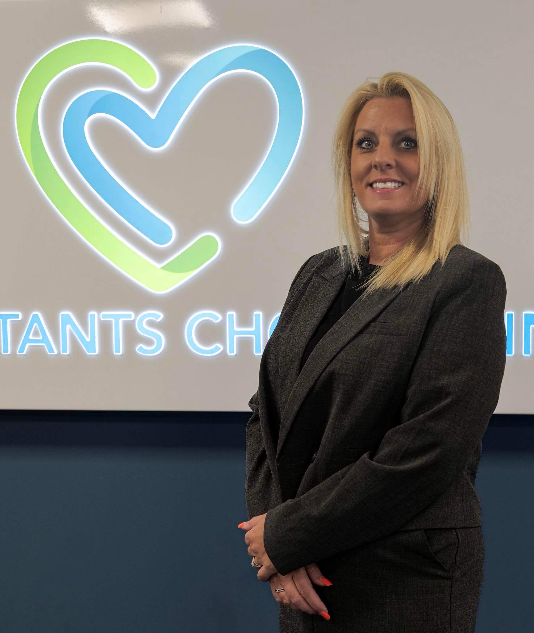 Consultants Choice Clinic representative standing in front of clinic logo in Stockton-on-Tees