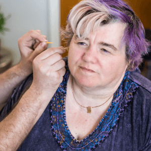 Anthony providing ear acupuncture using the NADA protocol to support stress and nervous system regulation